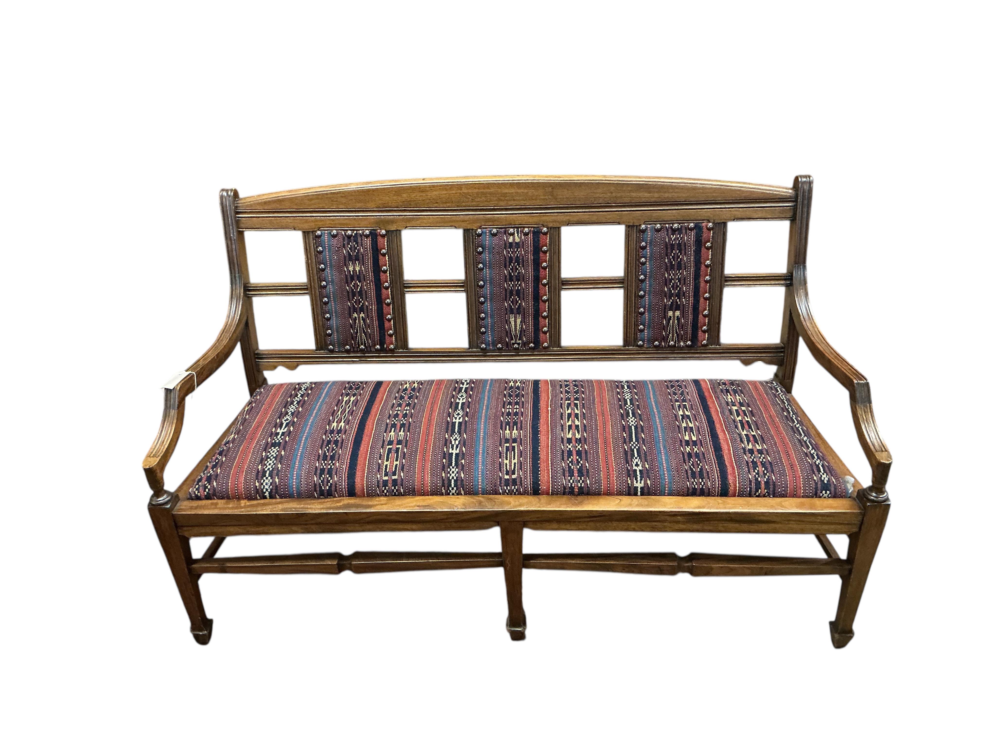 A late Victorian Aesthetic period walnut bench / settee, width 138cm, depth 50cm, height 80cm